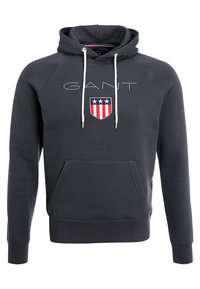 Felpa con cappuccio blu navy in cotone, dotata di tasca a marsupio frontale, coulisse bianche e un logo sul petto caratterizzato da strisce rosse, bianche e blu.
