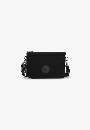 Black nylon crossbody bag with a zip closure, featuring a round embossed logo and adjustable strap with metallic hardware. Compact design.