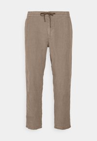 Linnenbyxor i ljusbrun färg med dragsko i midjan, smalnande ben och en slät yta, utan synliga fickor eller dekorationer.