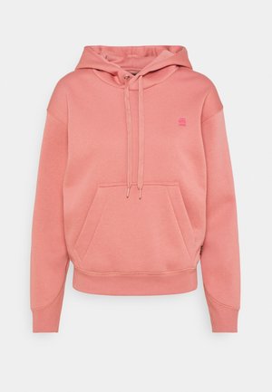 Sweat à capuche rose avec poche kangourou devant et fermeture par cordon, avec petit logo sur la poitrine.