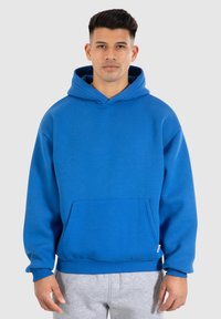 Hoodie bleu en coton texturé, avec une grande poche avant, une capuche à cordon de serrage et des poignets et un ourlet côtelés.