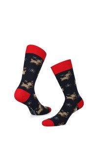 Granatowe skarpetki z wzorem w renifery z kreskówki, z czerwonym ściągaczem, piętą i palcami. Wykonane z miękkiego materiału. Wzór zawiera akcenty w postaci płatków śniegu.