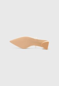 Nude high-heel shoe with a pointed toe and triangular heel. Made of smooth material with textured sole for grip.