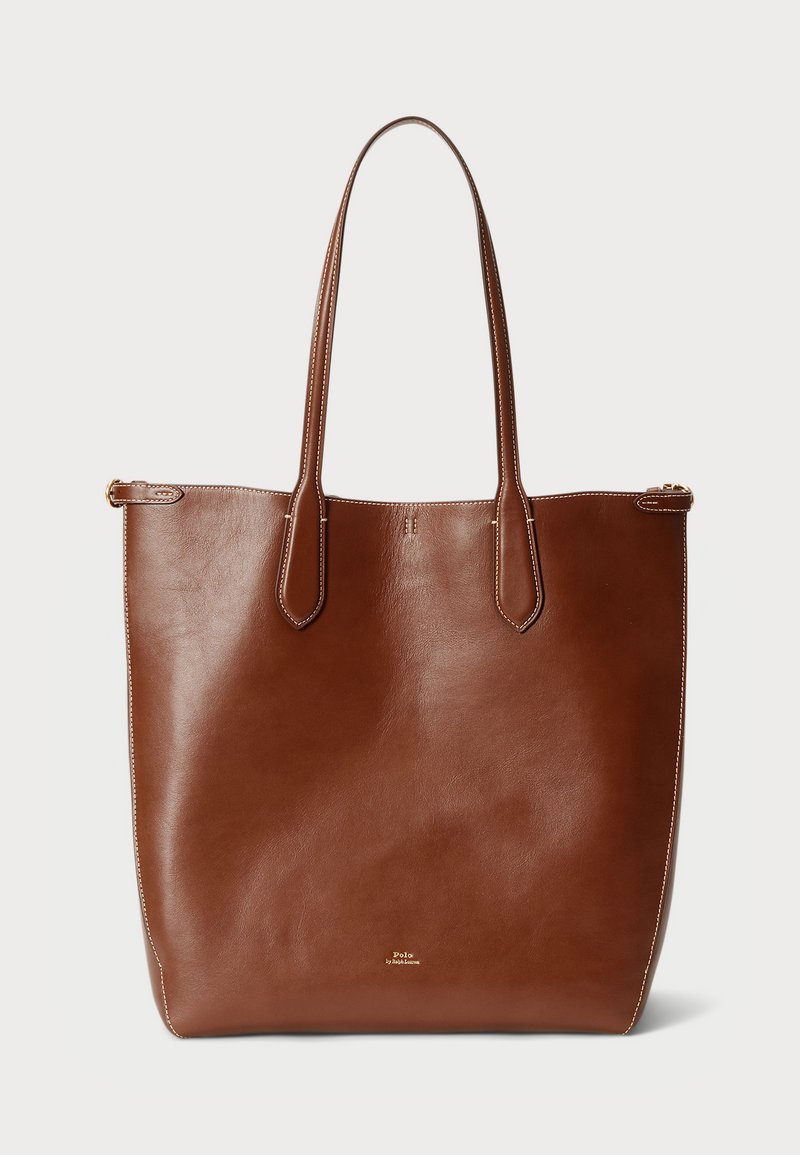 Ruda odinė rankinė su dviem ilgomis rankenomis, lygiu paviršiumi ir minimalistiniu dizainu. Apima subtilius siūlus ir užtrauktuką.