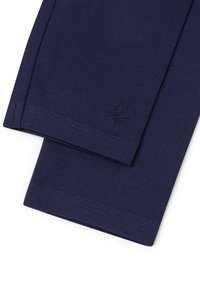 Leggings in cotone blu navy con una texture liscia, design aderente e orli cuciti, con un piccolo logo ricamato vicino all'orlo.