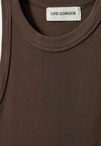 Brown ribbed tank top with a crew neckline. Tag reads "SOFIE SCHNOOR." Fabric texture is smooth with vertical lines.