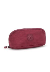 Astuccio per penne rosso, con zip e forma arrotondata, realizzato in tessuto testurizzato. Presenta una toppa con logo e un tirazip per un accesso facilitato.