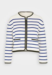 Bomullsk cardigan med vit bas och blå horisontella ränder, svart dragkedja och fickor. Kort längd och rund halsringning.