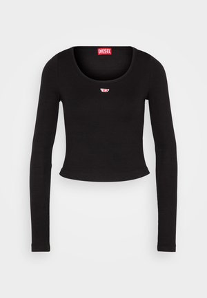 Black long-sleeve crop top made from ribbed fabric. Features a scoop neckline and a small red and white logo patch on the chest.