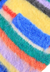 Colorful woolen fabric with stripes in yellow, blue, green, red, orange, and purple. Soft texture and varied width of stripes.