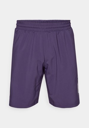 Lilla træningsshorts med elastik i taljen, glat tekstur og sidelommer. Har en længde til midten af låret og et enkelt design.