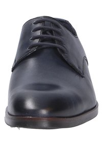 Zwarte leren verstelbare dresschoenen met een ronde neus, een glad oppervlak en subtiele stikseldetails. De zool lijkt iets gestapeld.