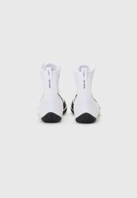 White boxing shoes with high tops, mesh texture, black sole, and a logo on the back. Features a zipper and cushioned ankle support.