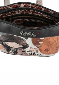 Borsa a tracolla nera e multicolore con arte grafica che rappresenta un personaggio, testo "Danza con la tua Alma" e dettagli in hardware argentato.