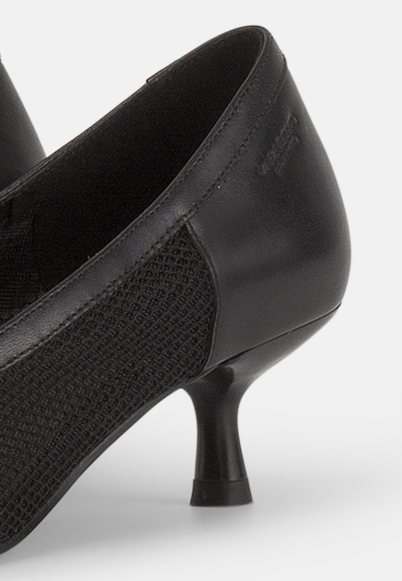 Schwarze High Heels aus glattem Leder mit strukturierten Seitenpaneelen aus Netzgewebe. Verfügt über einen kurzen, ausgestellten Absatz und eine runde Zehenpartie.