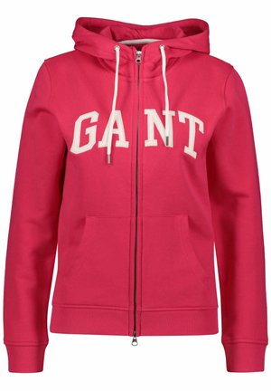 Roze hoodie met ritssluiting en een capuchon, witte trekkoorden en het 'GANT' logo in dikke letters. Beschikt over voorkruiken en geribbelde manchetten. Zachte stoftextuur.