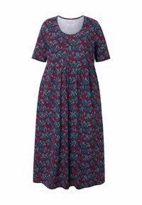 Kaupungissa lyhythihainen mekko tummasta kankaasta, jossa on kukkakuosi pinkeillä ja teal-värisillä kukilla, pyöreä pääntie ja ryhmitelty vyötärökohta.