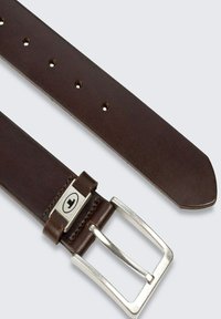 Brown leather belt with metal buckle, featuring multiple holes for adjustment. Smooth texture, tapered end, and subtle stitching detail.