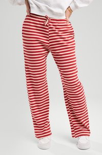 Red and beige striped lounge pants with a ribbed texture, elastic waistband featuring a drawstring, and side pockets.