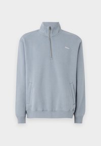 Light blue sweatshirt made of soft material with a half-zip collar, side pockets, and ribbed cuffs at the sleeves and bottom hem.