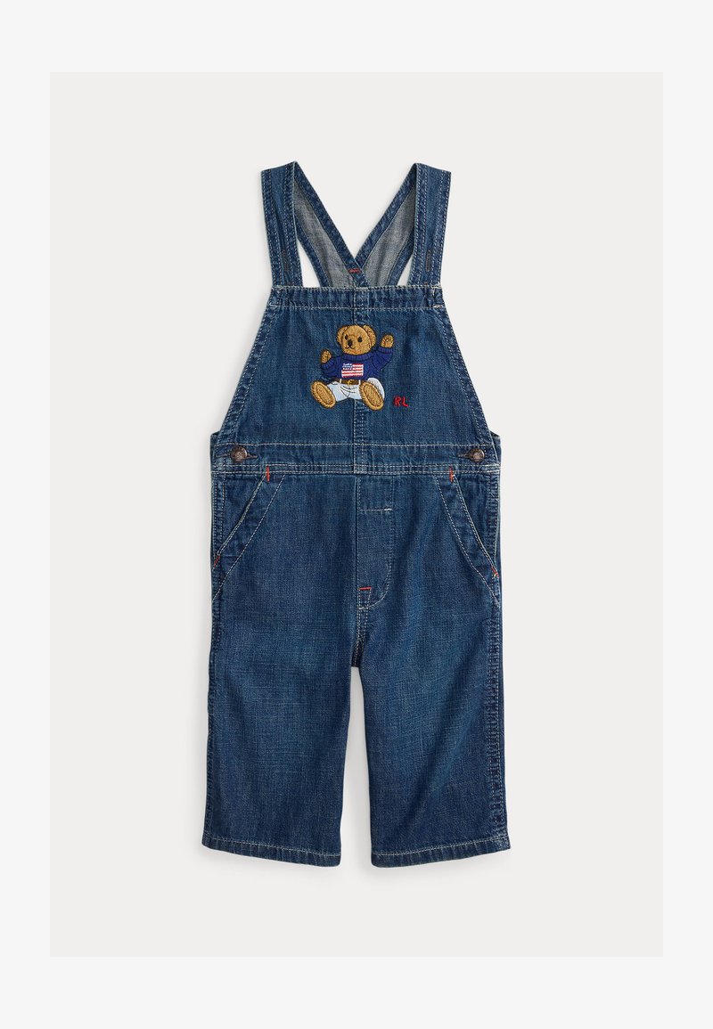 Μπλε τζιν σαλοπέτα με διασταυρωμένες τιράντες, που διαθέτει κεντητή αρκούδα και το "RL" εμπρός, καθώς και πλευρικές τσέπες.