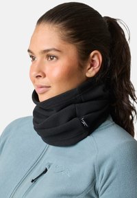 Black fleece neck gaiter with textured pleats, worn over a light blue fleece jacket. Features a small logo tag on the gaiter.