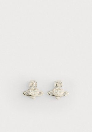 Silver earrings featuring a heart-shaped design with a ring around it, embellished with small clear stones and a detailed cross accent.