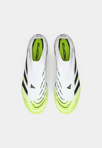 White and neon yellow Adidas Predator laceless soccer cleats with black stripes, viewed from above on a white background.
