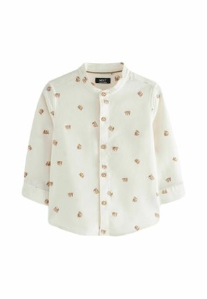 Chemise blanche à manches longues pour tout-petit avec imprimés de visage d'ours brun, boutons en bois sur le devant et col officier.