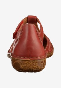 Red leather sandal with open-back design, textured sole, decorative stitching, and cut-out accents for breathability.