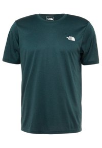 Camiseta de manga corta en tejido verde azulado oscuro, con cuello redondo y un pequeño logotipo blanco en el lado izquierdo del pecho. Textura suave, sin patrones.