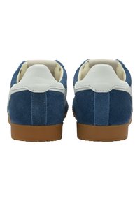 Blue suede sneakers with white leather accents, featuring a low-profile design and brown rubber soles. Soft interior lining for comfort.