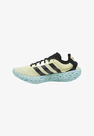 Hellgelbe Sportschuh mit schwarzen Streifen, strukturiertem Mesh-Obermaterial und einer einzigartigen aqua-blauen, gepolsterten Sohle mit Perforationen.
