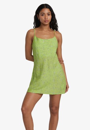Green floral mini dress with thin straps, featuring a soft fabric and a pattern of small flowers throughout the surface.