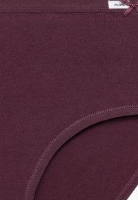 Bordowe bawełniane majtki o gładkiej fakturze, z szerokim elastycznym pasem i małą ozdobną kokardką z przodu.