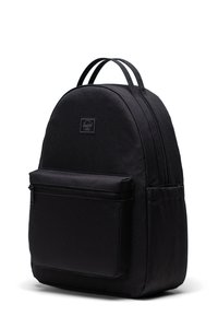 Black backpack made of durable fabric, featuring a rounded shape, double zipper, front pocket, and adjustable straps. Minimalistic design.