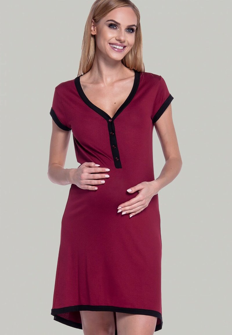 Maternity dress in burgundy with a black neckline and short sleeves. Features a button placket and a loose fit, made of soft fabric.