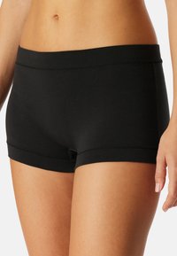 Black stretch shorts with a smooth waistband, featuring a snug fit and clean hem. The fabric appears soft and lightweight.