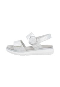 White sandal featuring perforated synthetic upper, adjustable strap with circular metallic accent, and a cushioned sole for comfort.