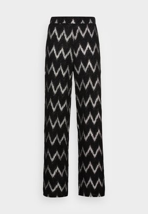 Black wide-leg pants with a white zigzag pattern and an elastic waistband, displayed against a plain light background.