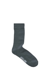 Donkergrijze sok van een gladde stof, met een effen ontwerp en een wit merklogo vlakbij de teen. Geen patronen of accenten aanwezig.