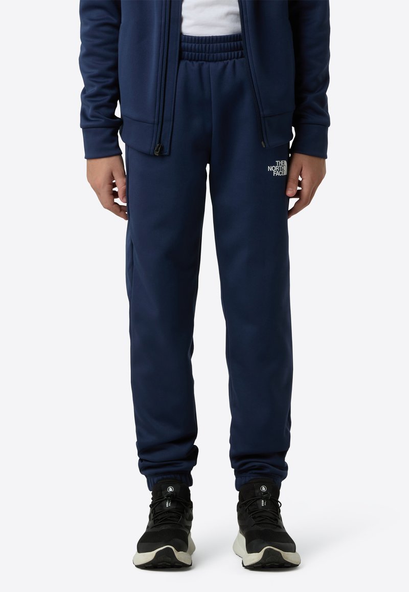 Navy blue sweatpants made of soft fabric, featuring an elastic waistband and side pockets, with a small white logo on the left thigh.