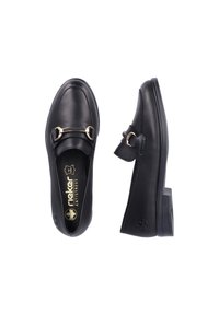 Mocassins en cuir noir avec un accent en métal doré, bout arrondi et petit talon. L'intérieur comporte la marque avec "Antistress" mentionnée.