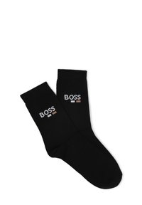 Calze di cotone nere con polsini a coste e logo "BOSS" ricamato in bianco, grigio e marrone sul lato esterno.
