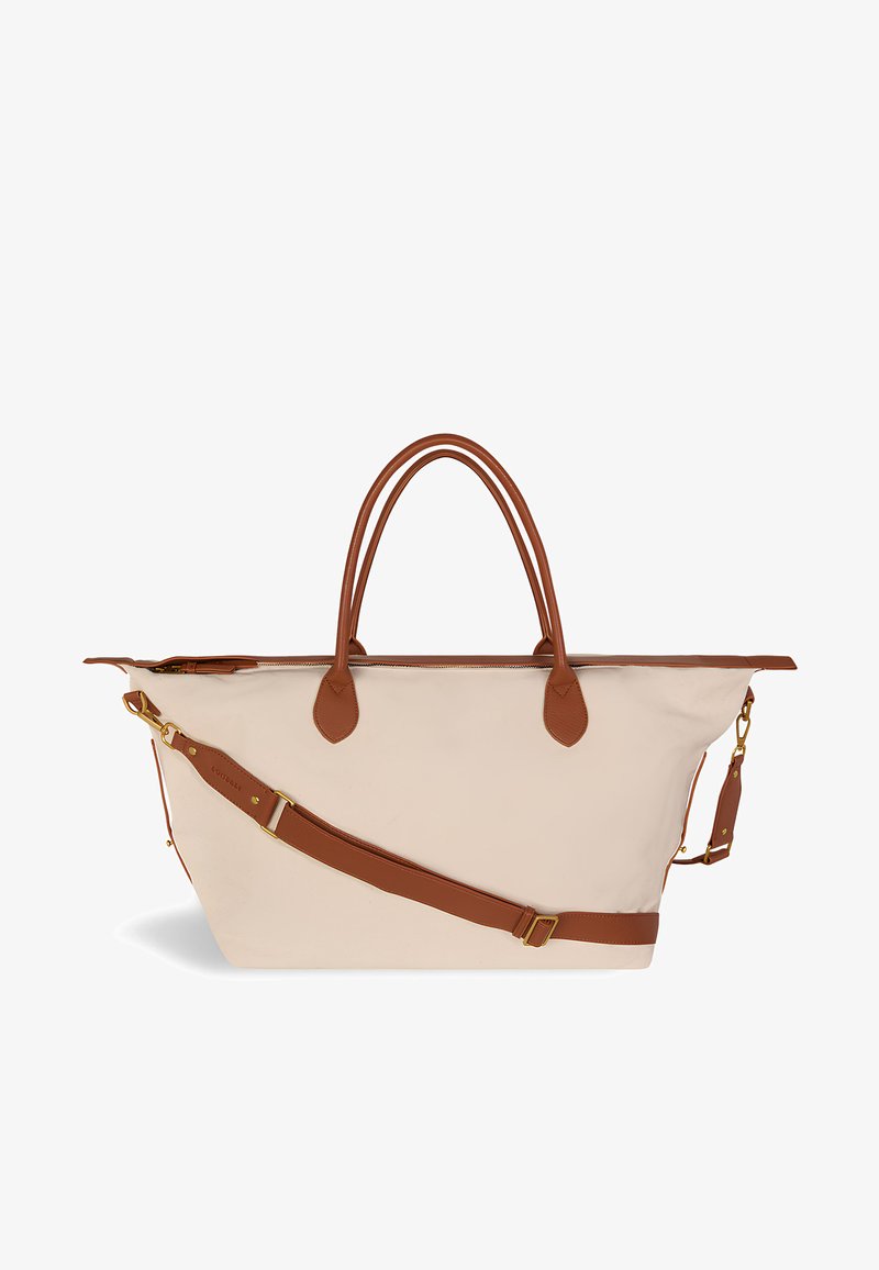 Bež velika torba s smeškim kožnim ručkama i podesivim remenom za rame, s zlatnim detaljima i zatvaranjem na zip.
