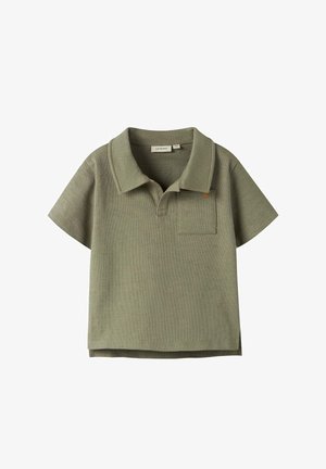 Polo de manga corta color verde oliva con textura, cuello abierto y pequeño bolsillo en el pecho del lado izquierdo.