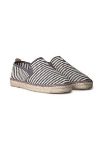 Espadrillas a righe con tomaia in tessuto intrecciato nero e crema, suola in corda di juta e pannelli elastici laterali per una facile calzata.