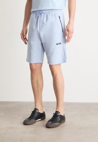 BOSS HEADLO - Spodnji deli trenirk - light blue