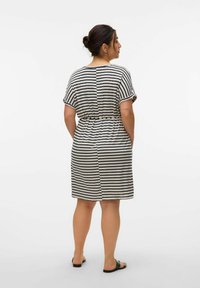 Gestreepte jurk met korte mouwen in creme en marineblauw, cinched in de taille. Beschikt over een relaxte pasvorm, zijzakken en een knielange zoom.