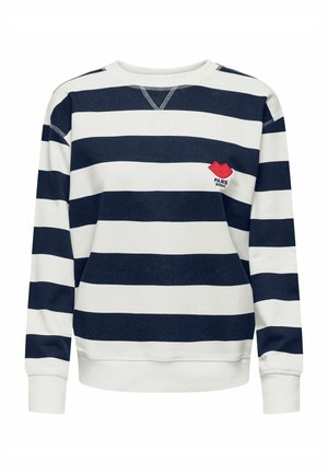 Sweatshirt à rayures horizontales bleu marine et blanches, manches longues, avec un petit patch rouge en forme de lèvres au-dessus du côté gauche de la poitrine portant l'inscription "PARIS STUDIO".